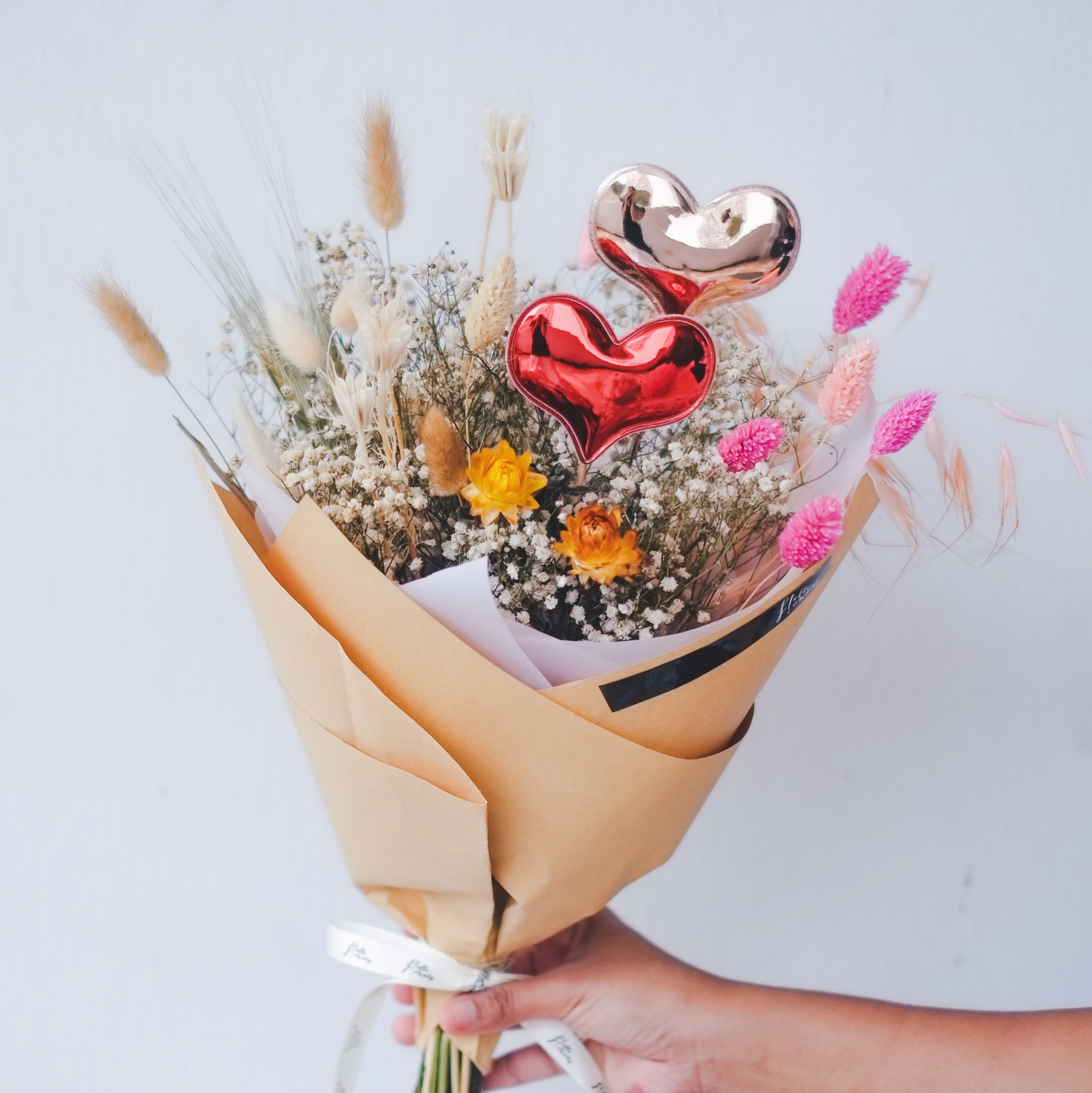 dried flowers bouquet with heart balloons